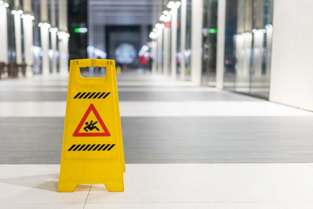 Slippery sign on wet floor in office building